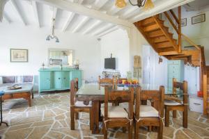 a kitchen and dining room with a table and chairs at Traditional family villa southern lefkada in Sívros