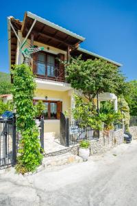 a house with a fence in front of it at Traditional family villa southern lefkada in Sívros