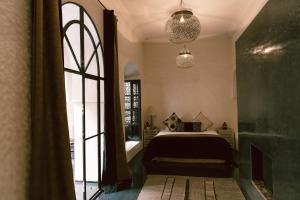 a bedroom with a bed and a window at Riad K in Marrakesh