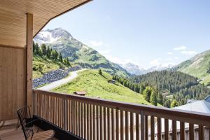 a balcony with a view of a mountain at HOLZGAUER HAUS in Warth am Arlberg