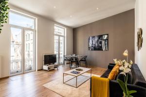 a living room with a couch and a table at Brussels centre Bnb Sablon I, II et V in Brussels