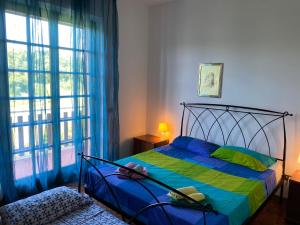 a bedroom with a bed and a large window at Appartamento VILLAMARE in Numana
