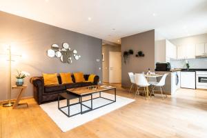 a living room with a couch and a table at Brussels centre Bnb Sablon I, II et V in Brussels