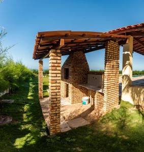une cheminée en briques avec un toit en bois dans l'établissement Aqua Villa by Garvetur, à Beberibe