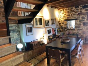 LA COROLLA في فيافيثيوسا: غرفة طعام مع طاولة وجدار حجري