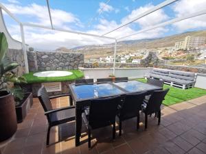 d'une terrasse avec une table et des chaises, ainsi que d'une vue sur le lac ou le jardin. dans l'établissement Apartamento vistas mar amplio, à Santa Cruz de Tenerife