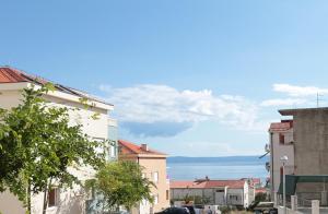 a city street with buildings and the ocean in the background at Modern Apartments in Makarska