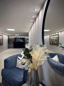 a lobby with a blue couch and a table at Luxury Suites Gema by Cadissa in Medellín