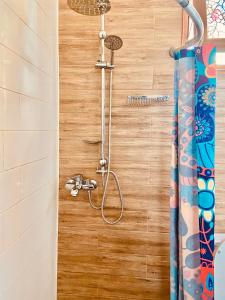 a shower with a shower head in a bathroom at 9 Borbalo Street Apartment with terrace in Tbilisi City