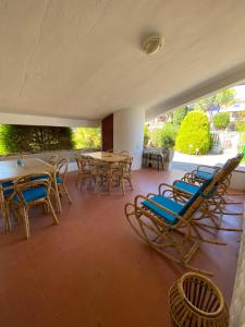 a patio with chairs and tables and a table and chairs at Appartamento VILLAMARE in Numana