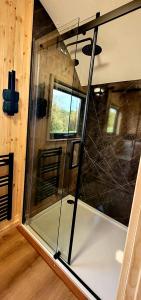 a glass door in a room with a window at Odli Glamping - Deri in Welshpool