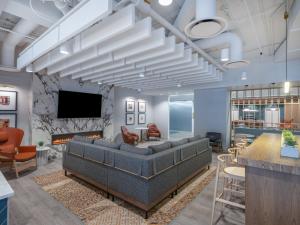 a lobby with a couch and a fireplace at Holiday Inn Chicago O'Hare - Rosemont by IHG in Rosemont