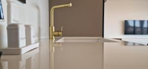 een badkamer met een wastafel en een gouden kraan bij Apartment Eclipse in Opatija +61 foto's