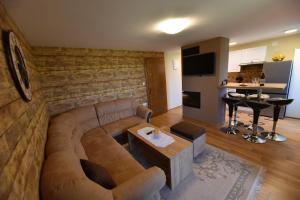 un soggiorno con divano e tavolo di Kuća za odmor Orly, jacuzzi, sauna, prekrasan pogled a Ludbreg