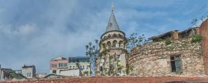a tall building with a steeple on top of a building at By Murat Royal Hotel Galata in Istanbul