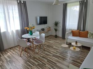 a living room with a table and chairs and a couch at Holiday Home Ostrun in Rakovica