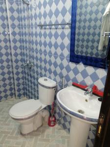 uma casa de banho com um WC e um lavatório em Appartement comfortable avec vue mer direct em Sidi Ifni