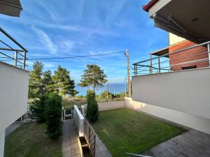 a view from the balcony of a house with a yard at Alba Mare Kallithea in Kallithea Halkidikis