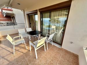 a balcony with a table and chairs on a balcony at Alba Mare Kallithea in Kallithea Halkidikis