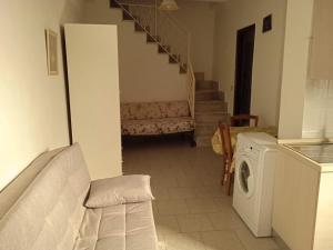 a living room with a staircase and a washing machine at CASA DI NONNA in Forza dʼAgro