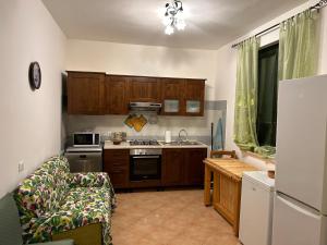 a kitchen with a couch and a stove top oven at Villetta sul mare in Resort Village in Campofelice di Roccella