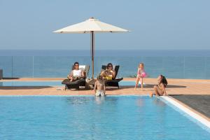 a group of people in a swimming pool at Belmar Spa & Beach Resort in Lagos