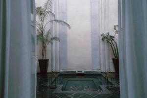 a swimming pool in a room with potted plants at Riad K in Marrakesh