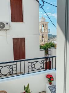 a balcony with a view of a church at Evagelias suite in Skopelos Town