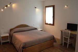 Rúm í herbergi á Hotel Agriturismo Al Luogo Del Giulio