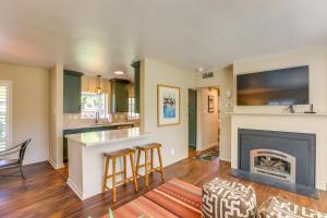 a living room with a fireplace and a tv at Modern Reno Abode Near Parks and Midtown! in Reno