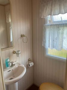 a bathroom with a sink and a window at The Lambourne in Dunoon