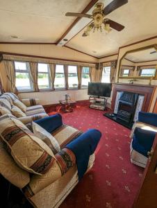 a living room with a couch and a television at The Lambourne in Dunoon