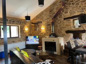 a living room with a couch and a fireplace at SANABRIA - Palacio de La Cuesta in Palacios de Sanabria