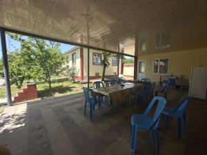 a room with a table and chairs and a large window at Vandam Luminous Villa in Gabala