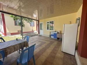 an empty room with a table and a refrigerator at Vandam Luminous Villa in Gabala
