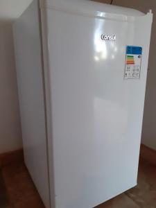 a white refrigerator with the word crush written on it at Chalés Bons Ventos - Icaraizinho in Icaraí