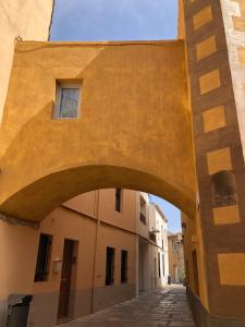 a building with an archway in a street at Apartaments L’ARC in Palafrugell