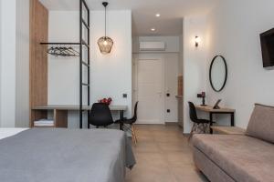 a bedroom with a bed and a desk in a room at Val Del Mar in Skala Fourkas
