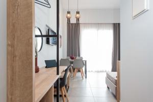 a dining room and living room with a table and chairs at Val Del Mar in Skala Fourkas