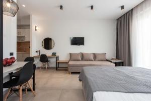 a bedroom with a bed and a couch and a table at Val Del Mar in Skala Fourkas