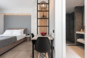 a bedroom with a bed and a desk and a table at Val Del Mar in Skala Fourkas