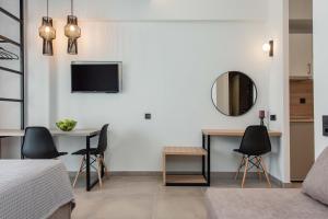 a bedroom with a bed and a table and a mirror at Val Del Mar in Skala Fourkas