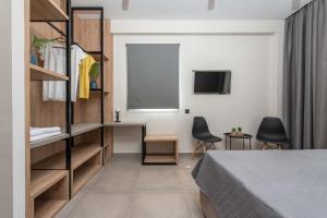 a bedroom with a bed and a desk and a chalkboard at Val Del Mar in Skala Fourkas