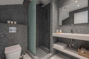 a bathroom with a toilet and a sink and a mirror at Val Del Mar in Skala Fourkas