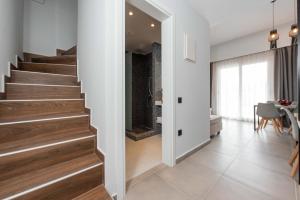 a hallway with stairs and a dining room with a table at Val Del Mar in Skala Fourkas