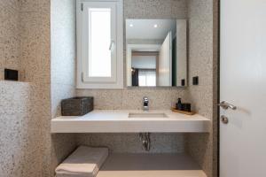 a bathroom with a sink and a mirror at Val Del Mar in Skala Fourkas