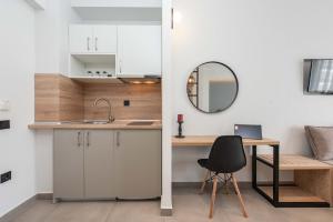 a kitchen with a desk and a chair and a mirror at Val Del Mar in Skala Fourkas