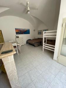 a room with two bunk beds and a table at Dimora Marina sul Gargano in Vieste