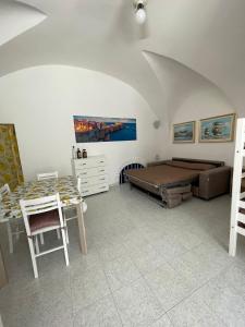 a bedroom with a bed and a desk and a table at Dimora Marina sul Gargano in Vieste