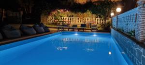 a swimming pool at night with blue illumination at Vila EN AD in Ksamil